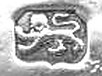 A hallmark punch photographed on a piece of silver